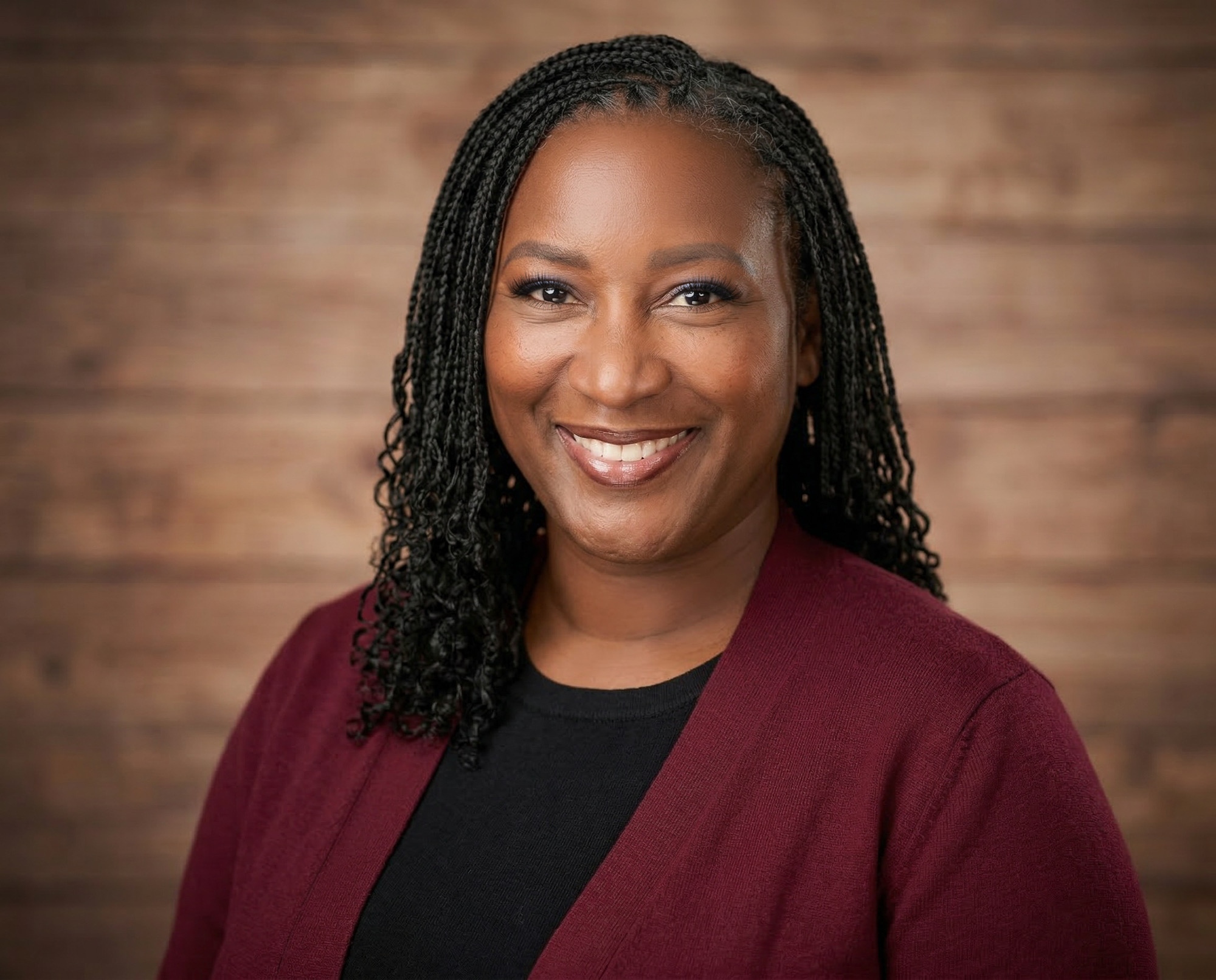 Portrait of Rev. Teela Ross in burgundy